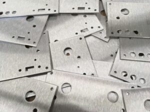 laser cut machined sheet metal front panels with brushed finish and precise internal cutouts